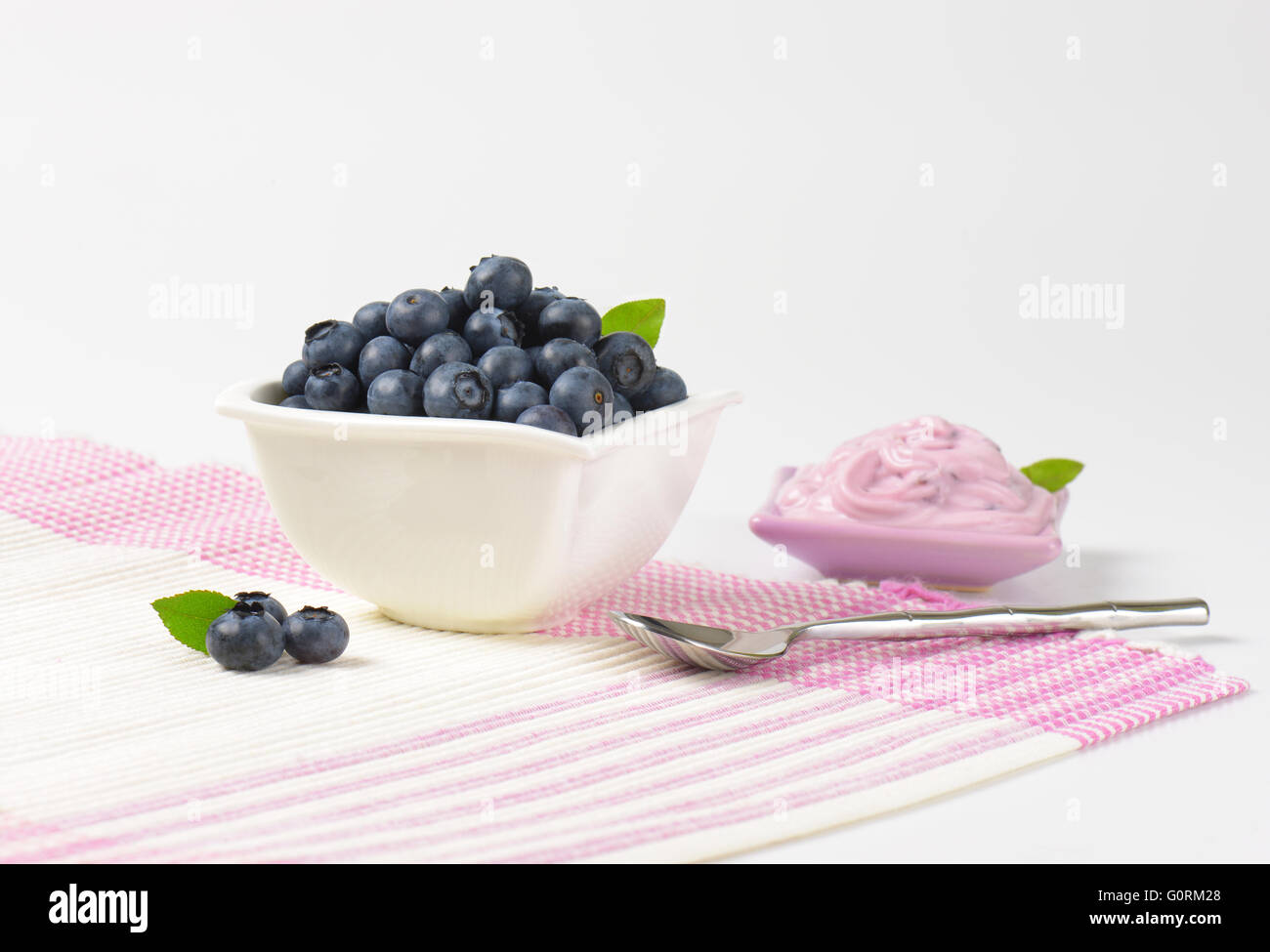 Bowl of fresh blueberries and blueberry yogurt Stock Photo