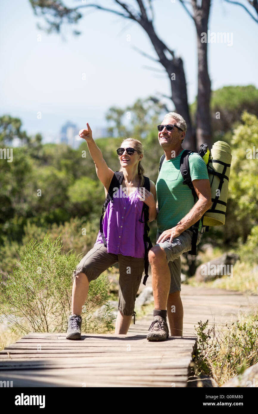 Couple pointing and smiling during a hike Stock Photo