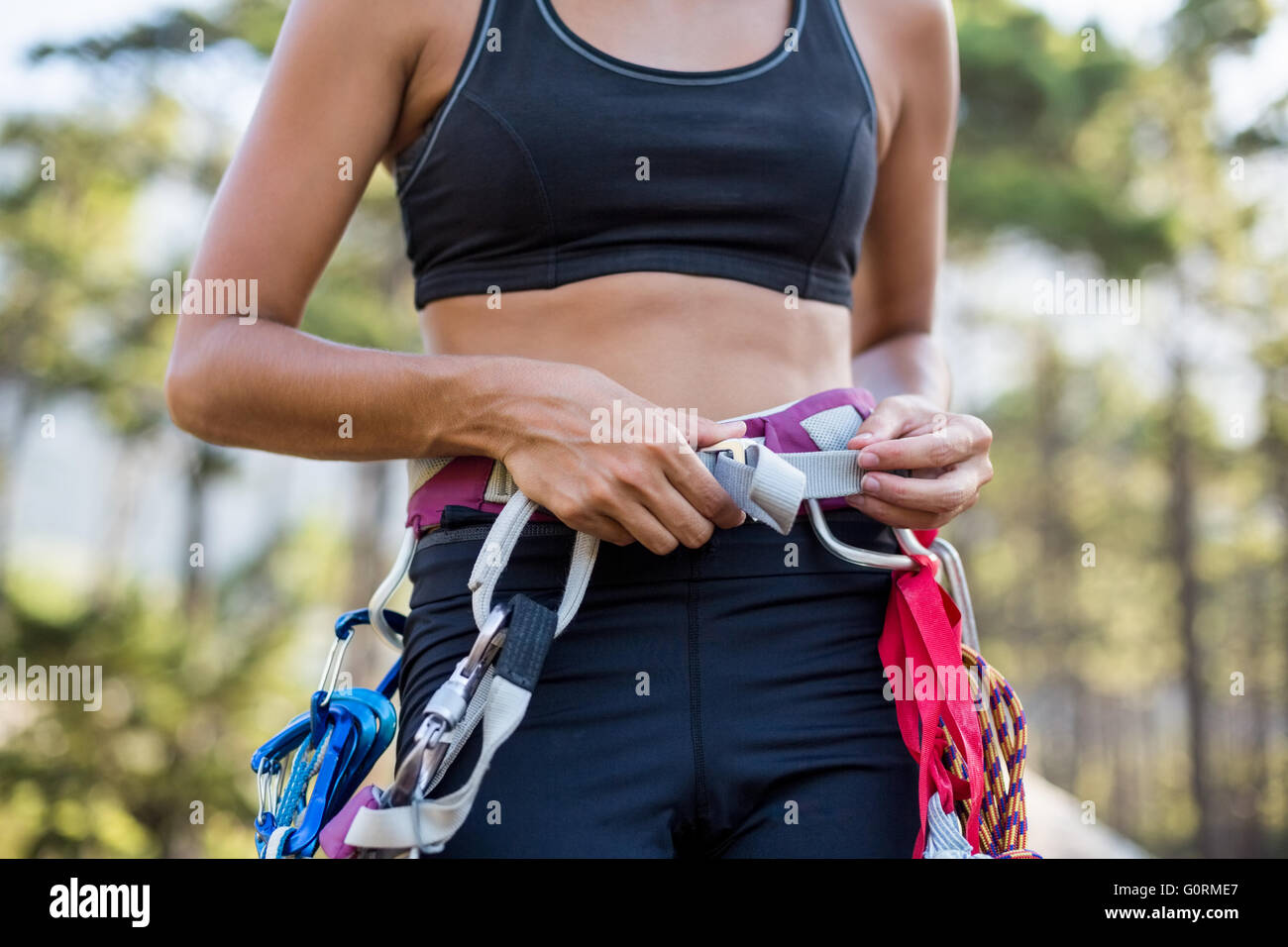 Young woman climbing on rope hi-res stock photography and images - Alamy