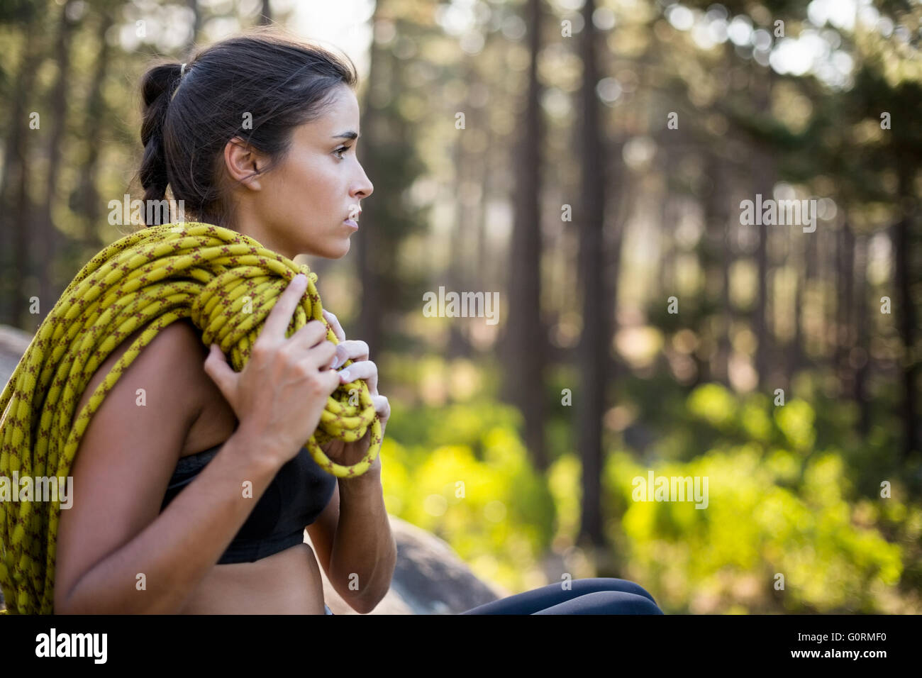 Woman sitting with climbing equipment Stock Photo
