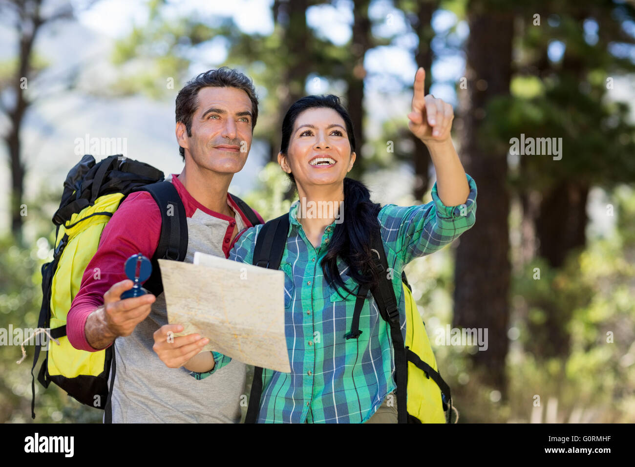 Couple pointing and holding a map Stock Photo
