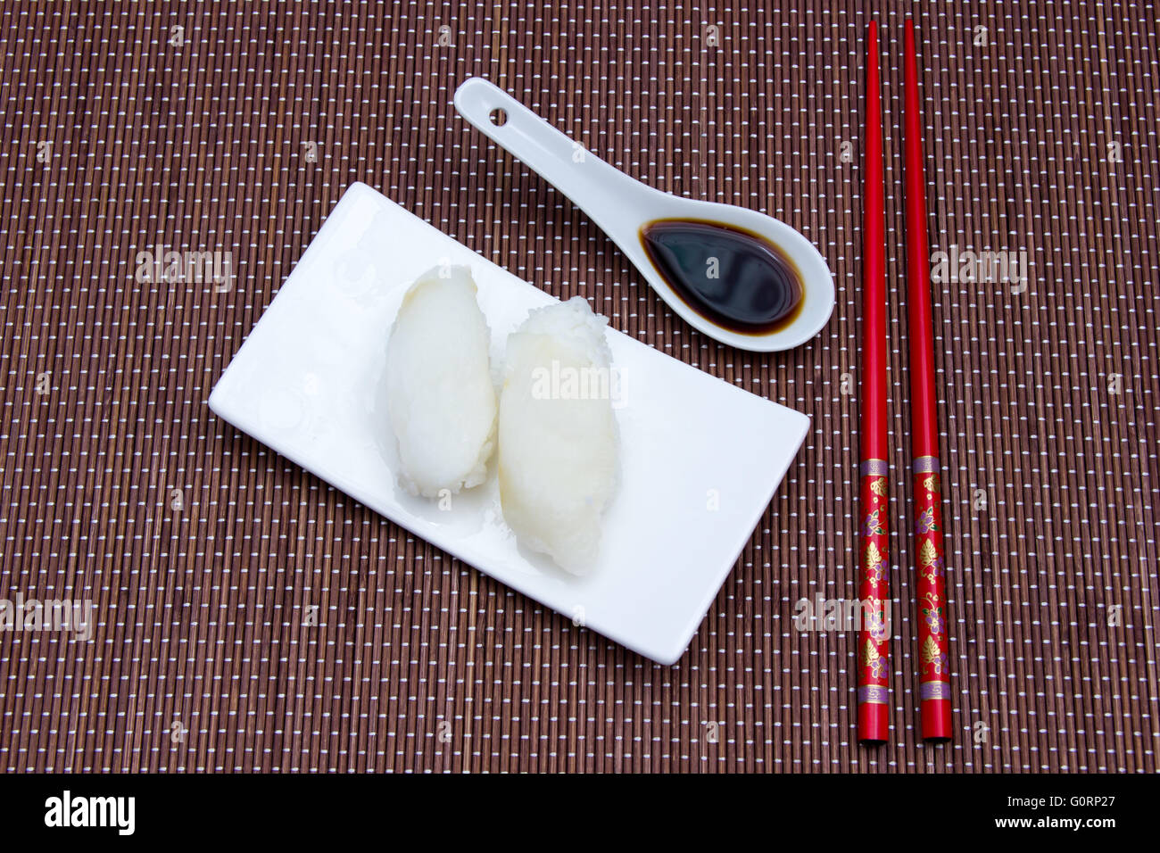 Nigiri with halibut on a placemat bamboo seen from above Stock Photo