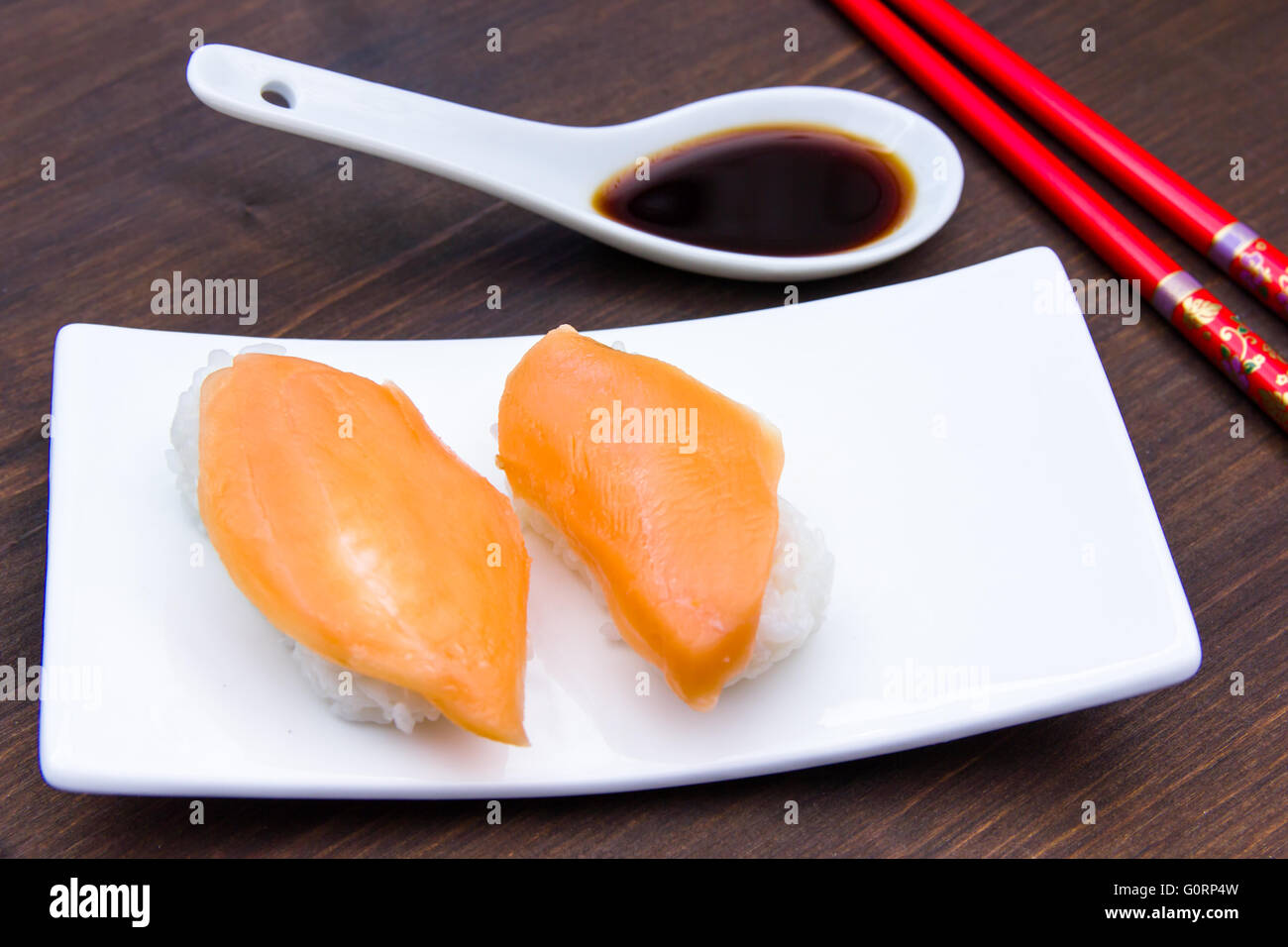 Nigiri with salmon on a wooden table seen up close Stock Photo