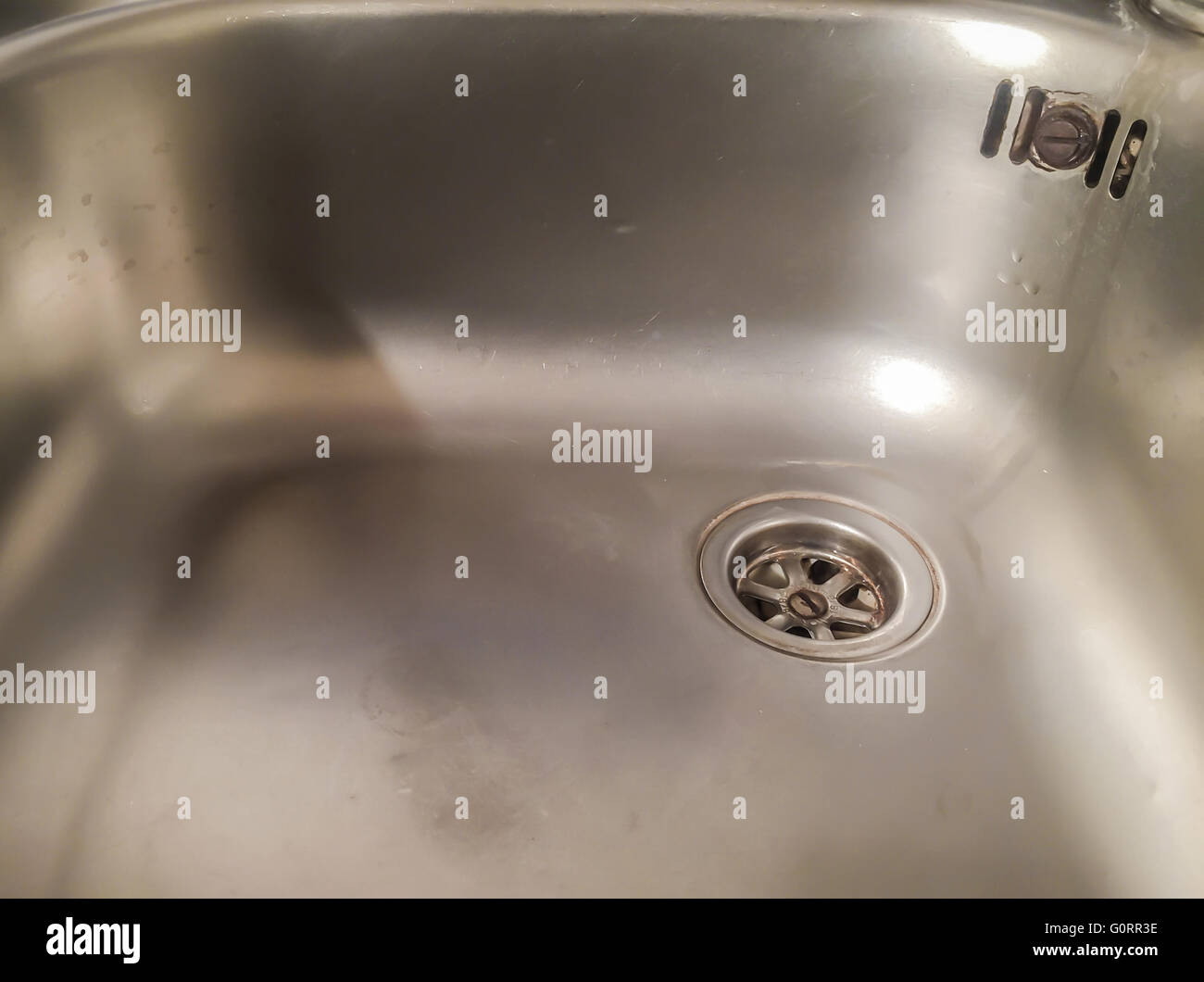 alluminium sink with rusty plug Stock Photo