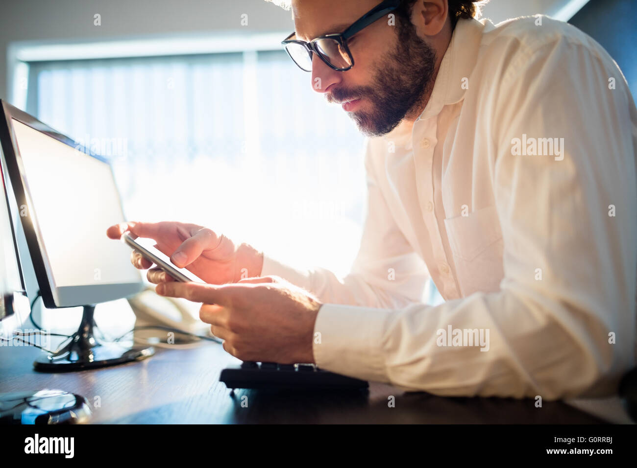 Businessman working and looking his phone Stock Photo