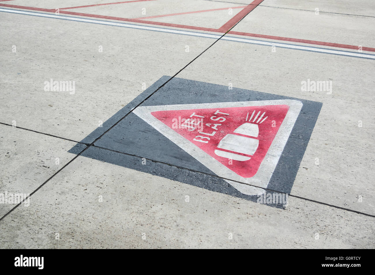 Jet blast warning sign painted on the ground of an airport apron Stock