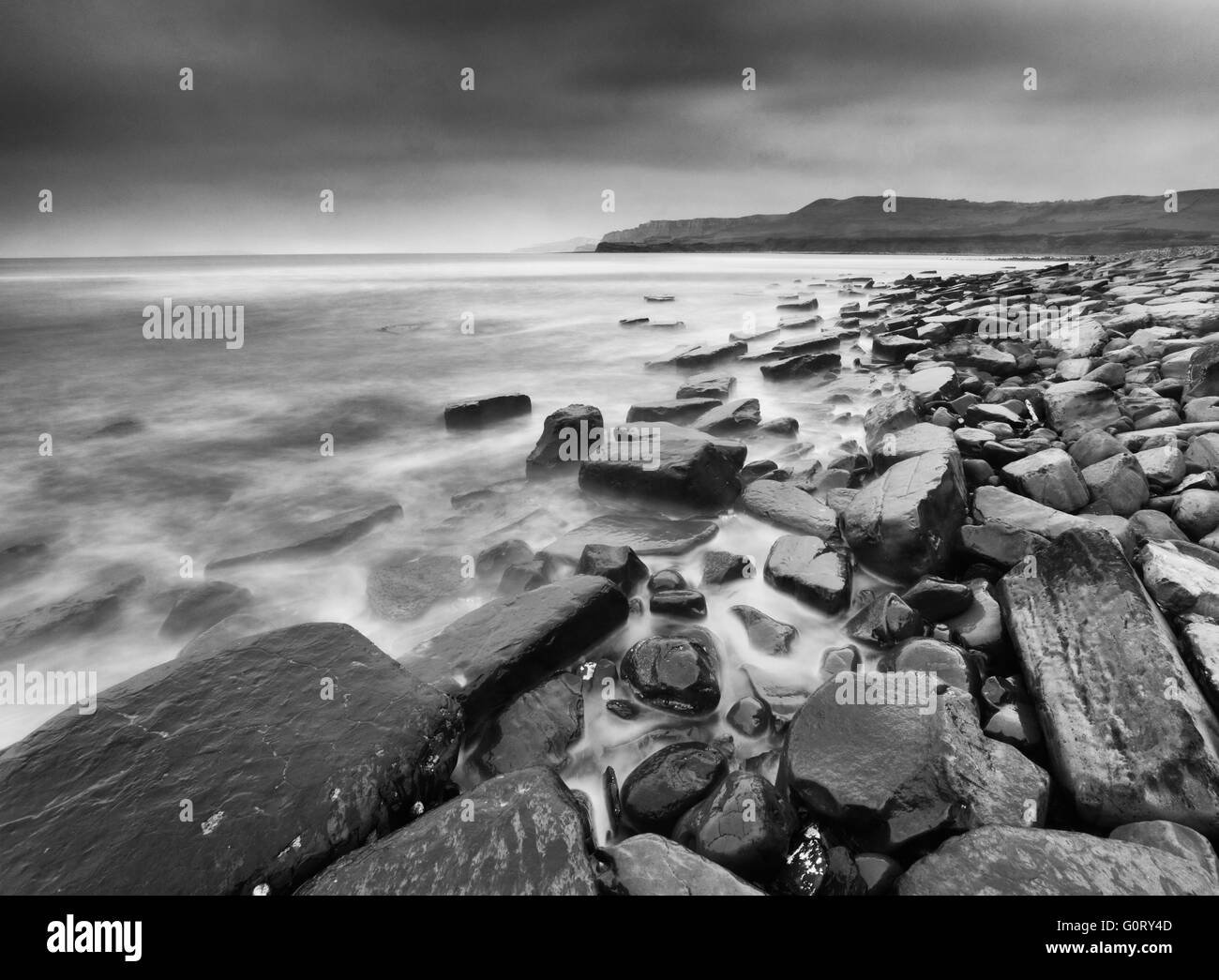 Cloudy Kimmeridge Bay, Dorset, England in black and white Stock Photo