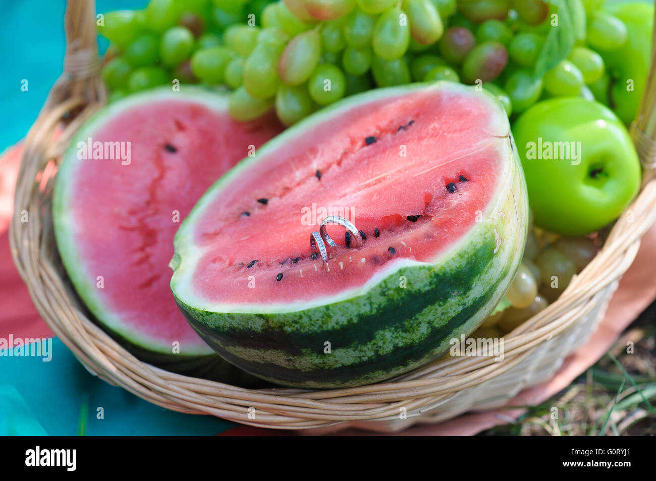Two wedding rings on half a watermelon Stock Photo - Alamy