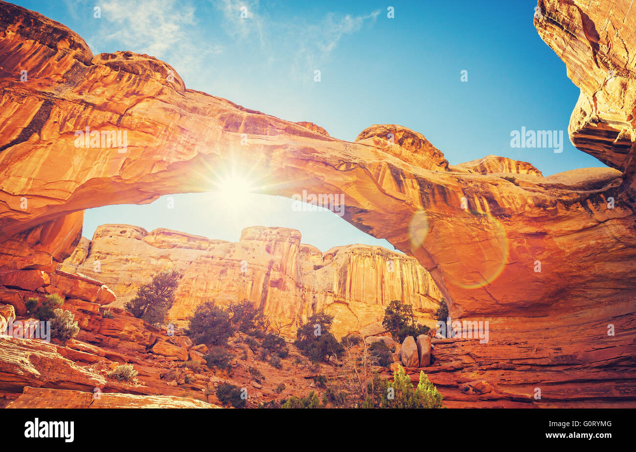 Vintage filtered Hickman Bridge at sunset with lens flare, Capitol Reef National Park in Utah, USA Stock Photo