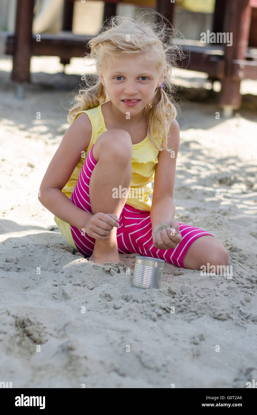 lovely kid playing in the sandbox Stock Photo