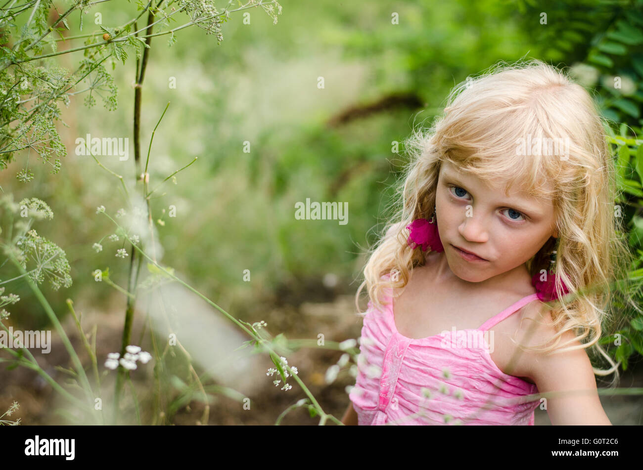 little kid in the green spring meadow Stock Photo