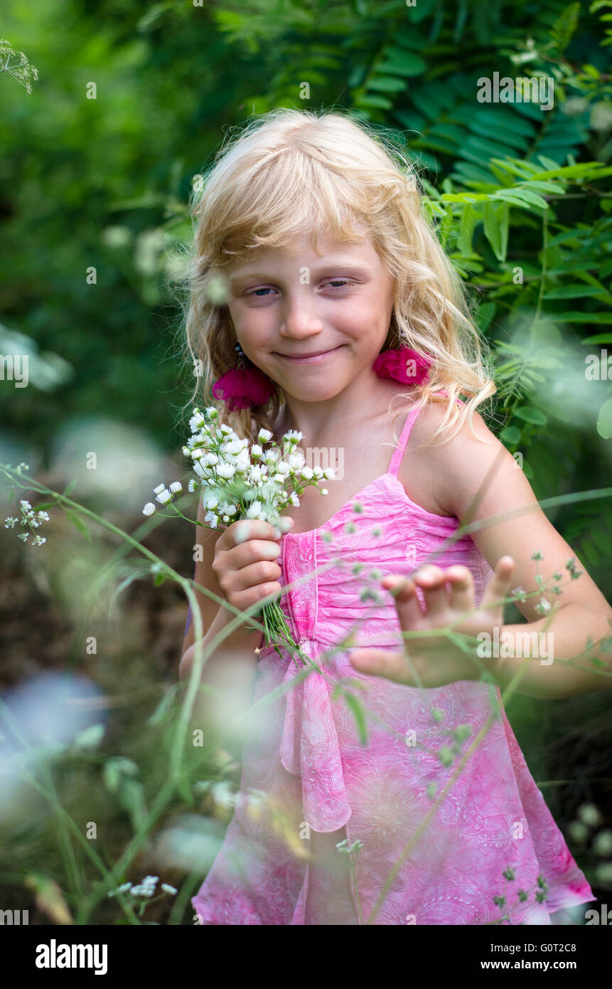 little kid in the green spring meadow Stock Photo