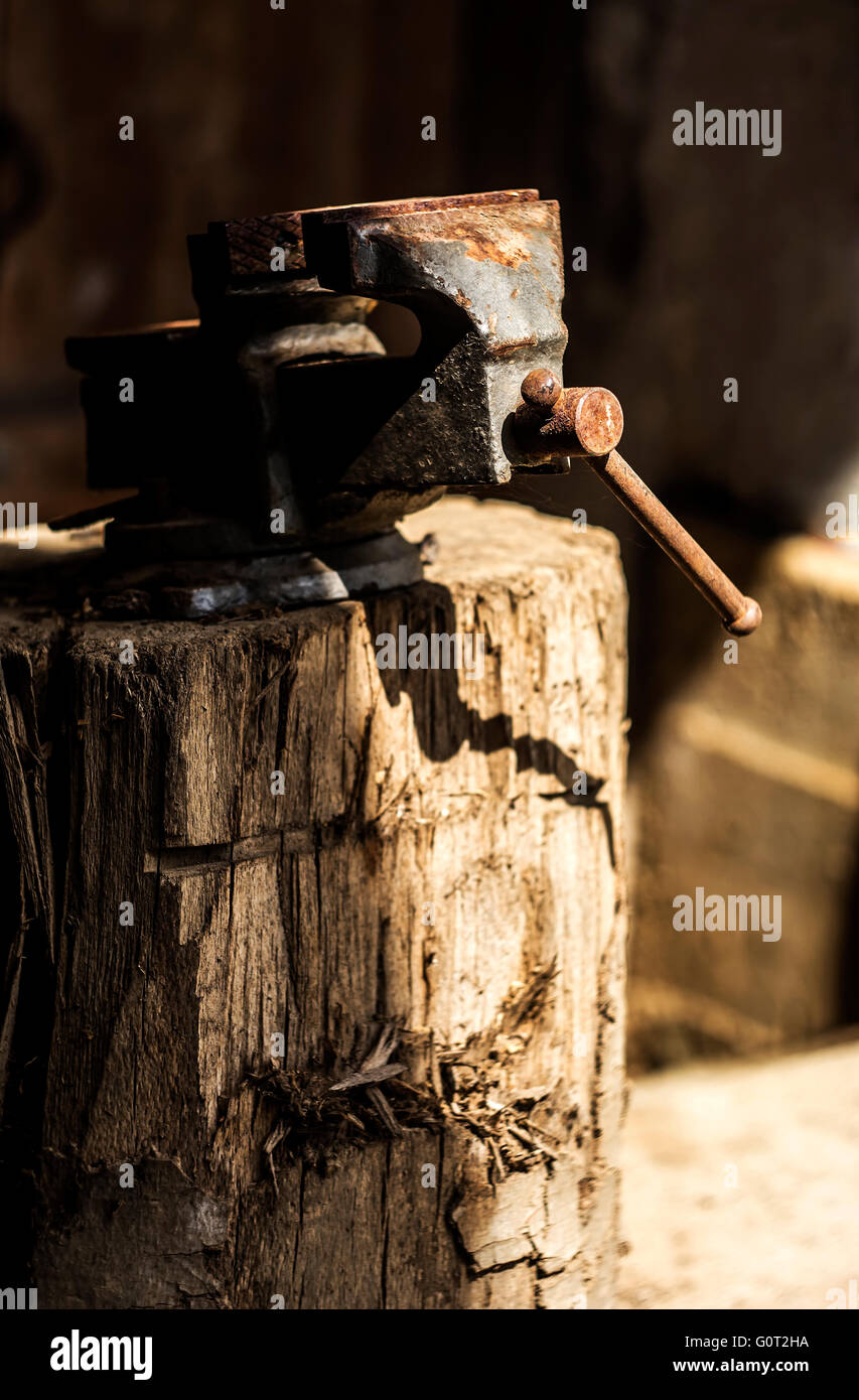 Metalworking hand tool on a tree stump. Stock Photo