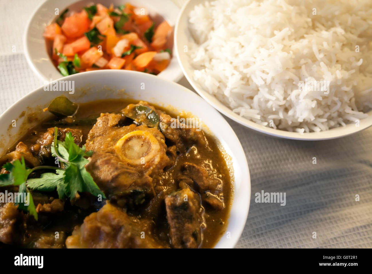 Traditional Indian Lamb Curry with rice and salad Stock Photo Alamy