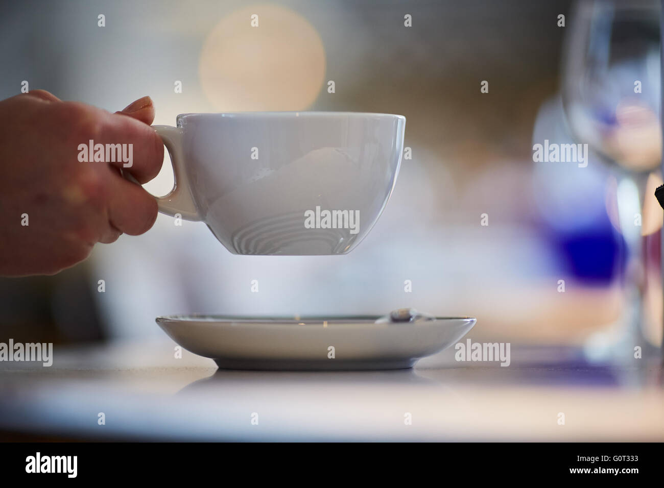 Coffee shop drinking cup  hand holding large coffee tea drink beverage hot white china mug saucer copyspace break time Stock Photo