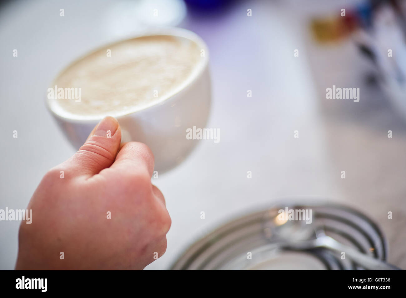 Coffee shop drinking cup  hand holding large coffee tea drink beverage hot white china mug saucer copyspace break time latta Stock Photo