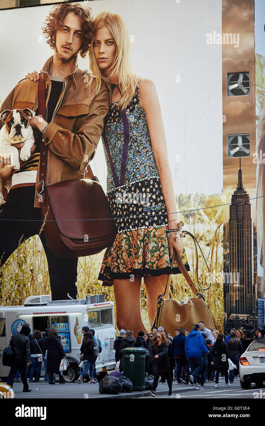 New york   Large oversized advert on 5th avenue covering shops people walking on sidewalk Stock Photo