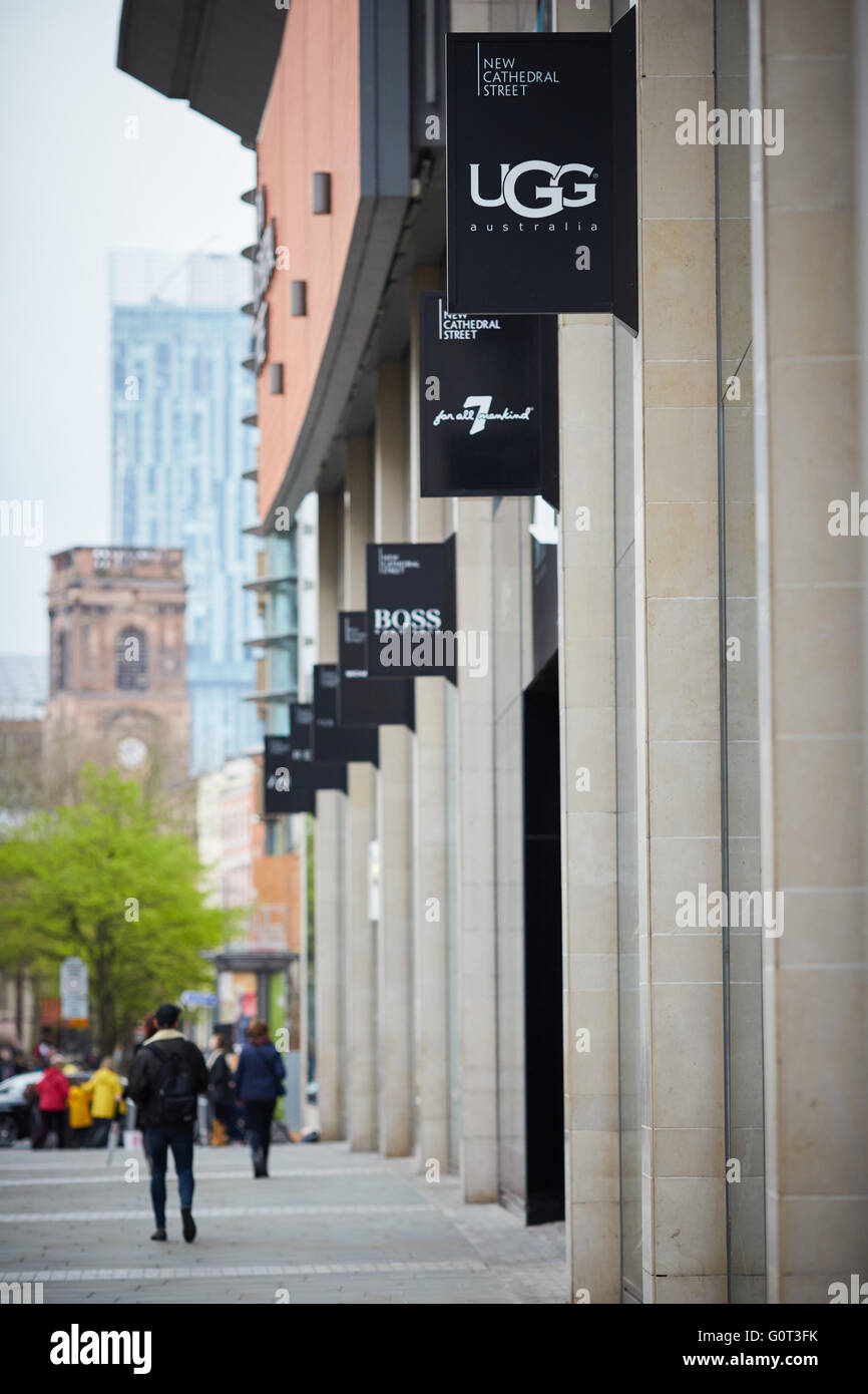 Manchester cathedral walk looking towards  St Ann's Square framed by Beethan tower ugg store sign Stock Photo