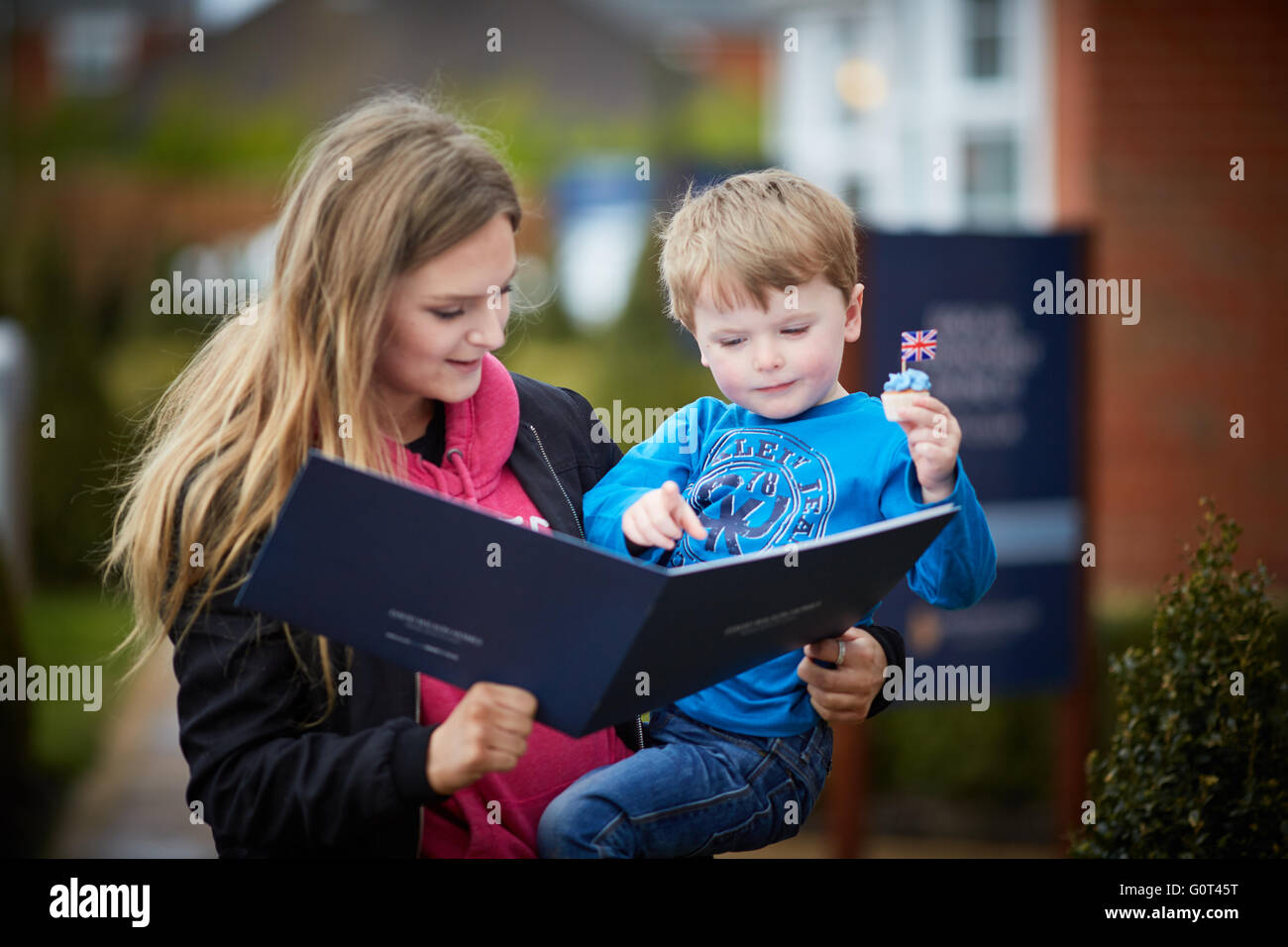 Younger brother older sister boy girl viewing houses showroom browsing