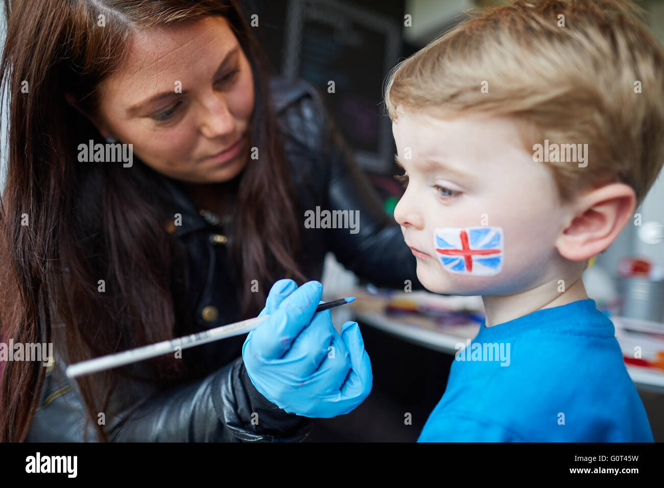 Young boy union jack flag faceprinting    Man men male his him he  lads boys Young kids children youngsters child toddlers adole Stock Photo