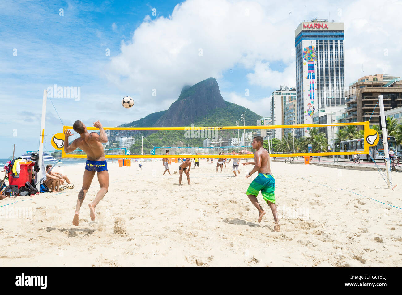 RIO DE JANEIRO - MARCH 17, 2016: Brazilian men play futevôlei (footvolley, combining football and volleyball) on Ipanema Beach. Stock Photo