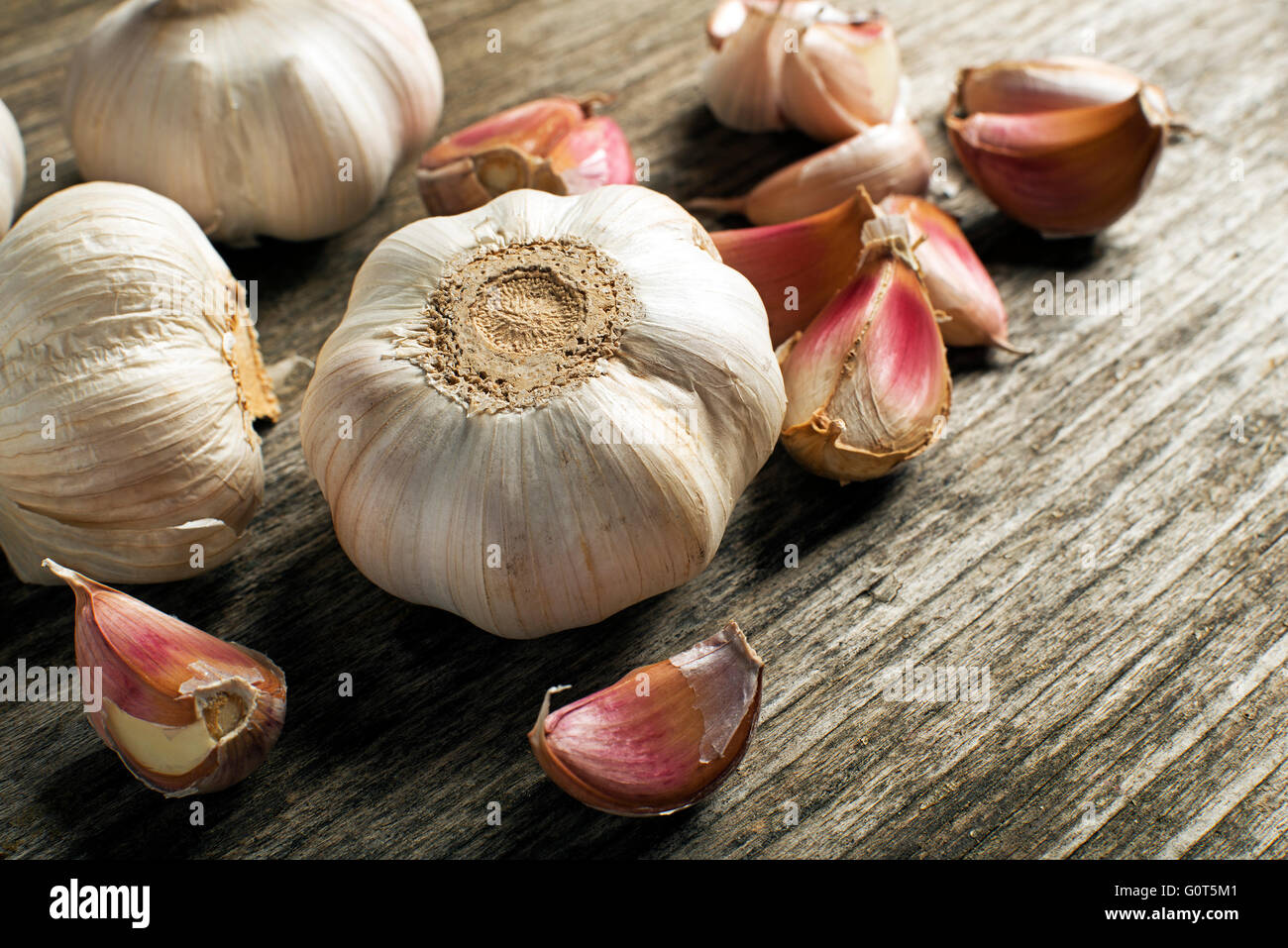 Garlic cloves on wooden background close up. Stock Photo