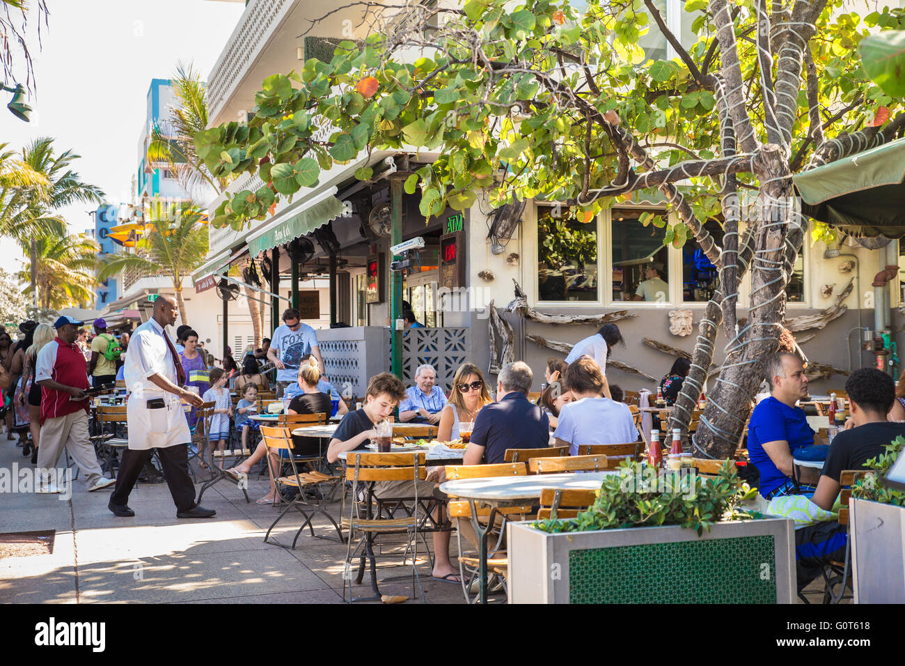 View of people dining outdoors along Ocean Drive in South Beach Miami Florida Stock Photo
