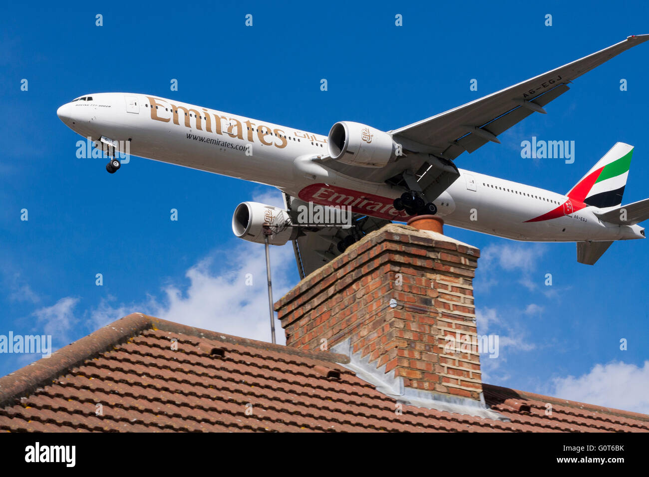 Emirates Boeing 777-31H(ER), registration / tail number A6-EGJ approaching Heathrow airport, London. UK. Stock Photo