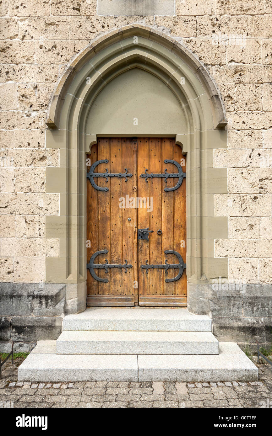 Brown church door with gothic stepped portal Stock Photo