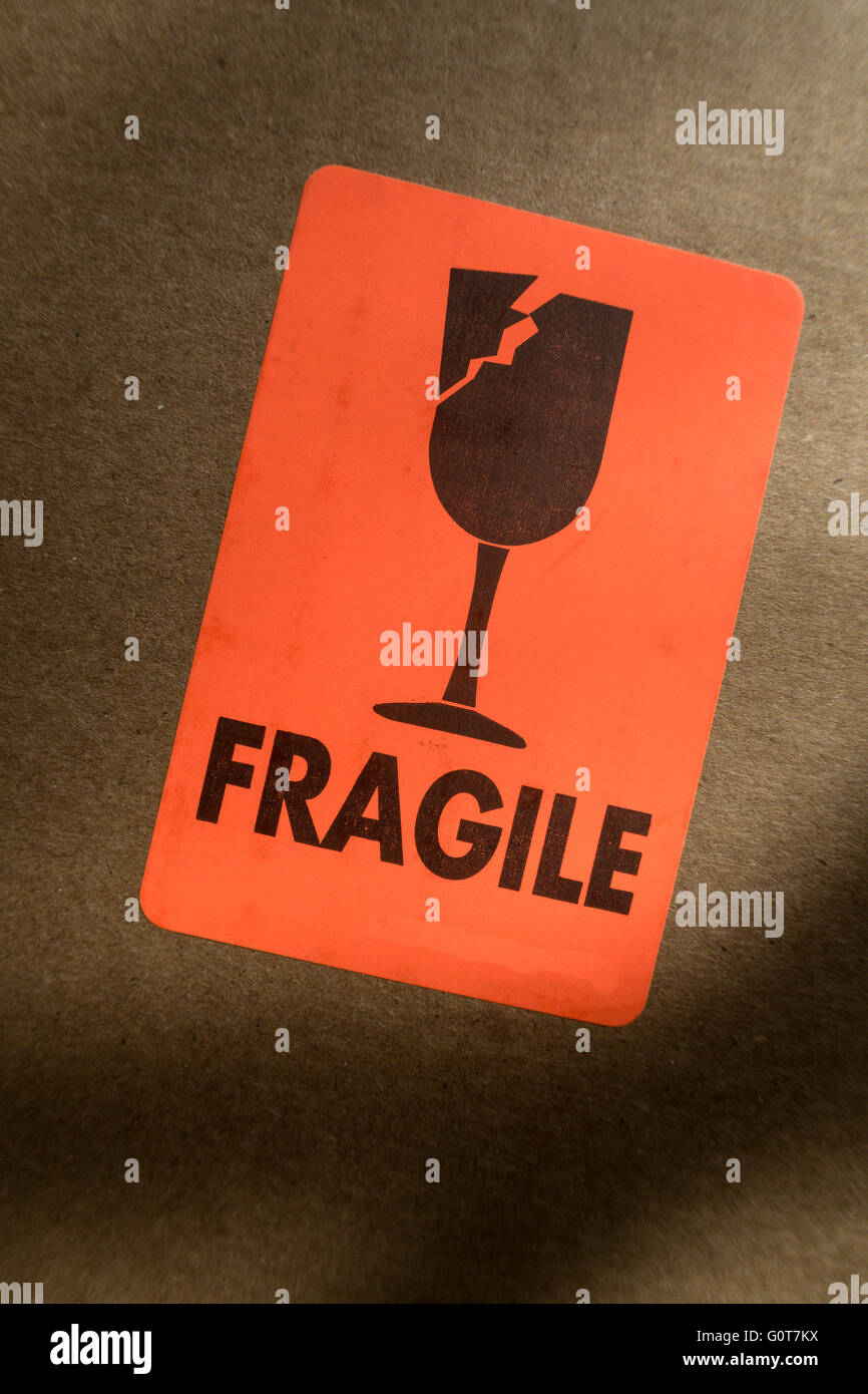Bright Orange and Black Fragile Sticker on a Cardboard Mailing Box, USA Stock Photo