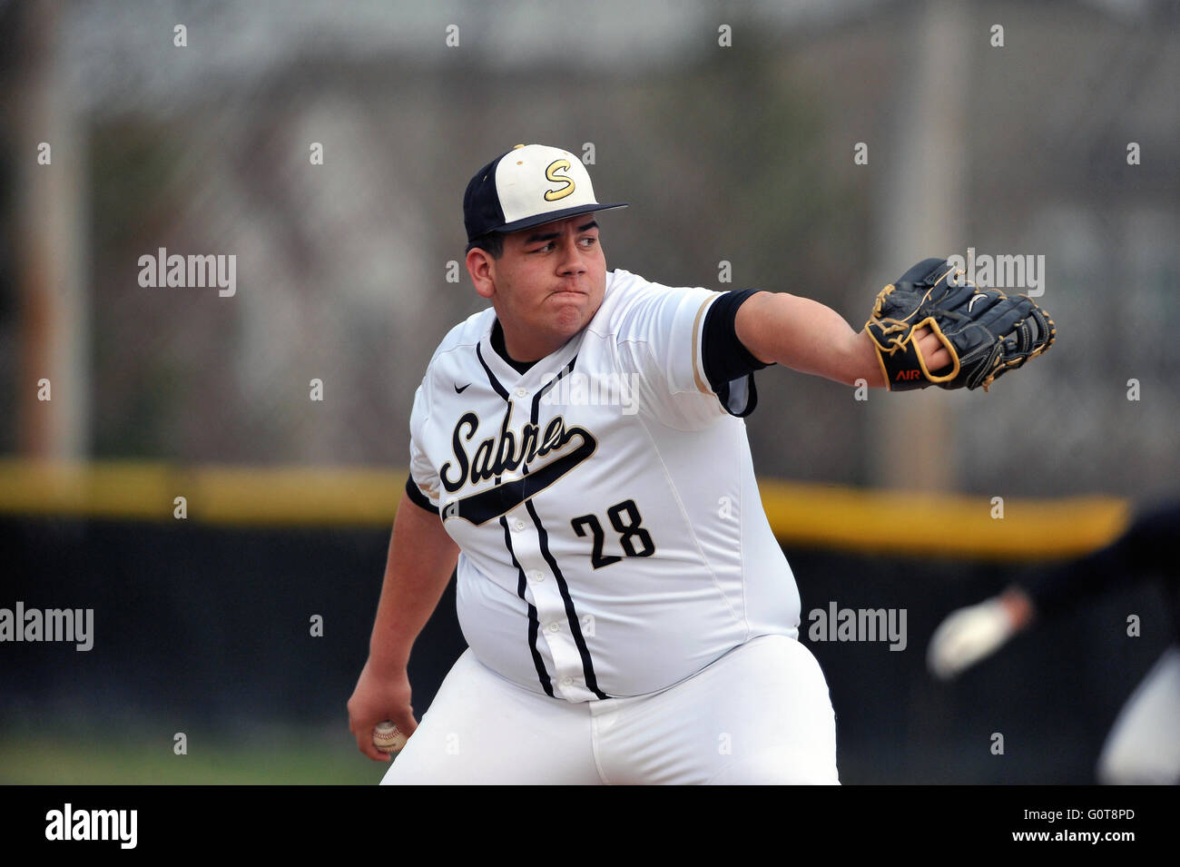 Righthanded pitcher delivering a pitch to a waiting hitter during a