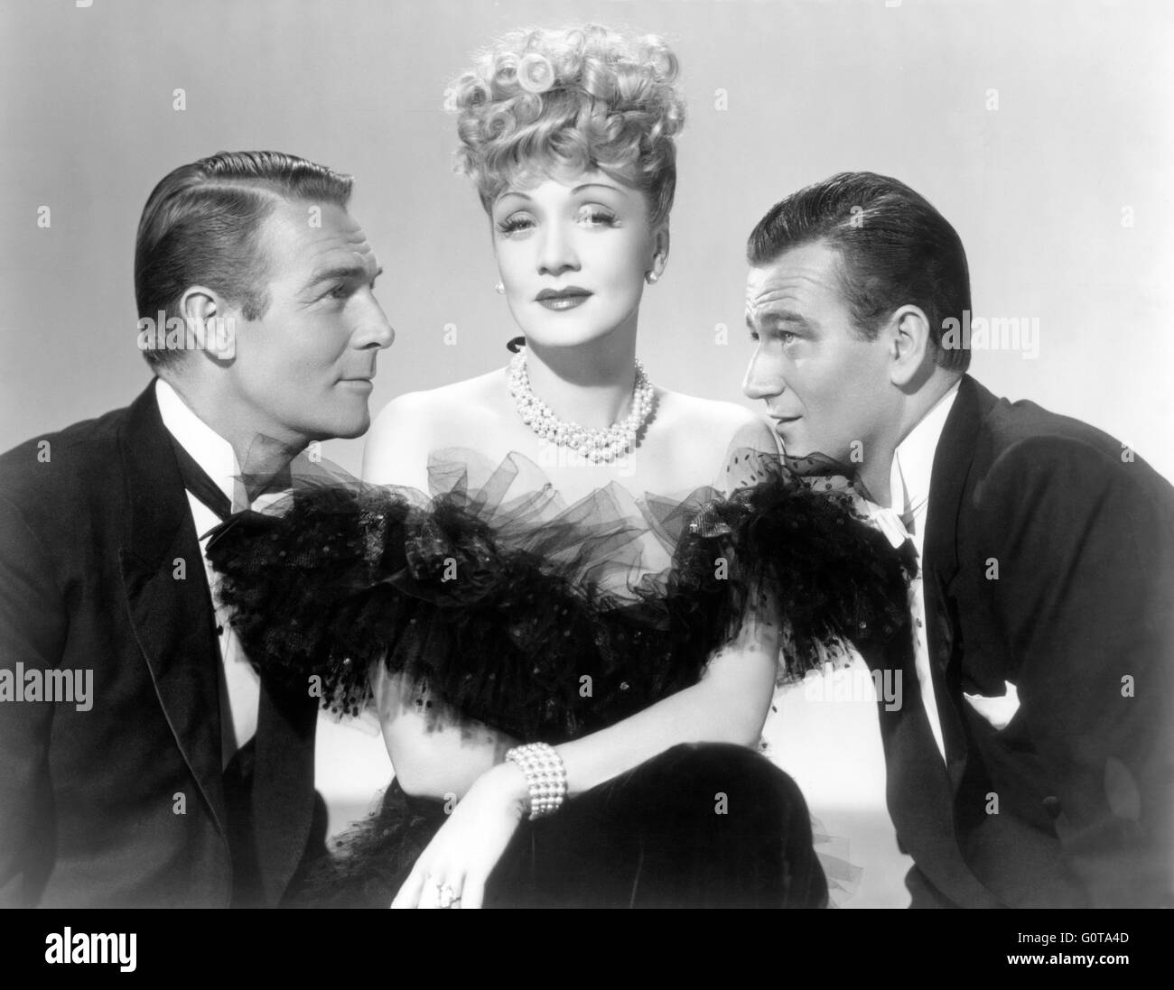 Randolph Scott, Marlene Dietrich and John Wayne / Pittsburgh / 1942 directed by Lewis Seiler (Universal Pictures) Stock Photo