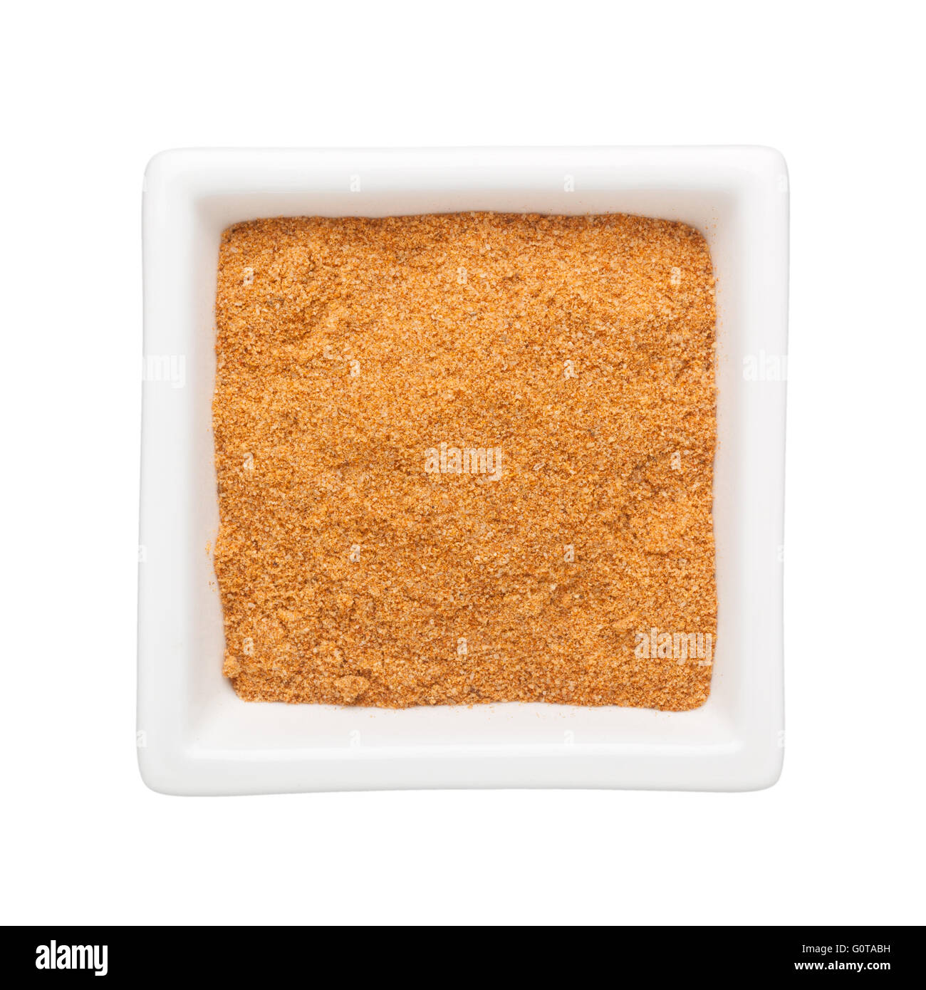 Curry powder in a square bowl isolated on white background Stock Photo