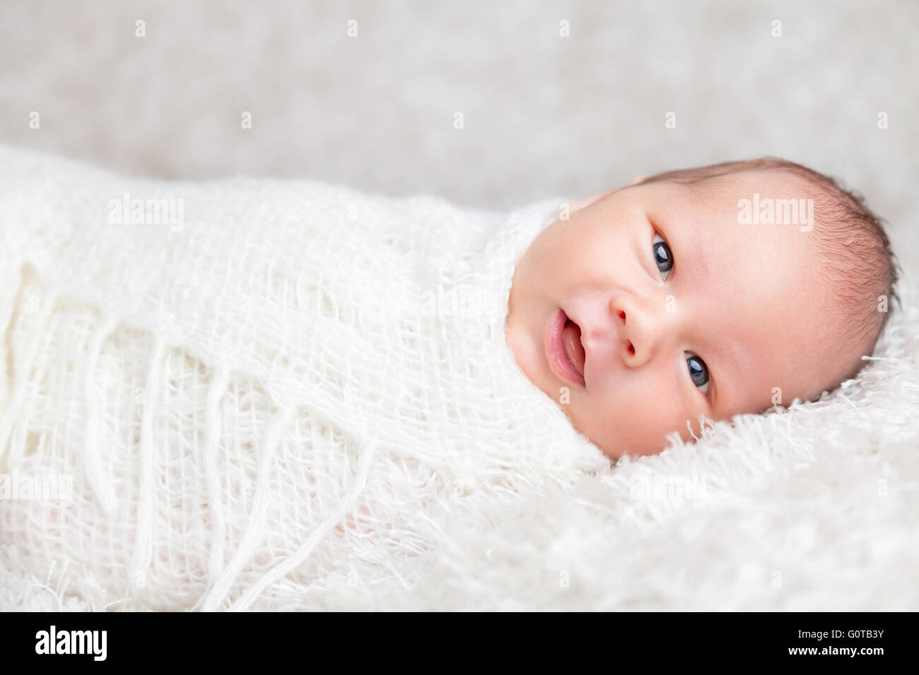 Beautiful newborn baby wrapped in a blanket Stock Photo