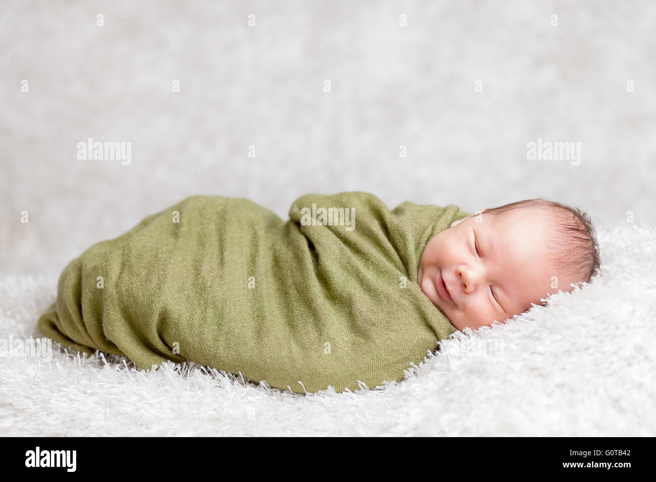 Beautiful newborn baby wrapped in a blanket Stock Photo