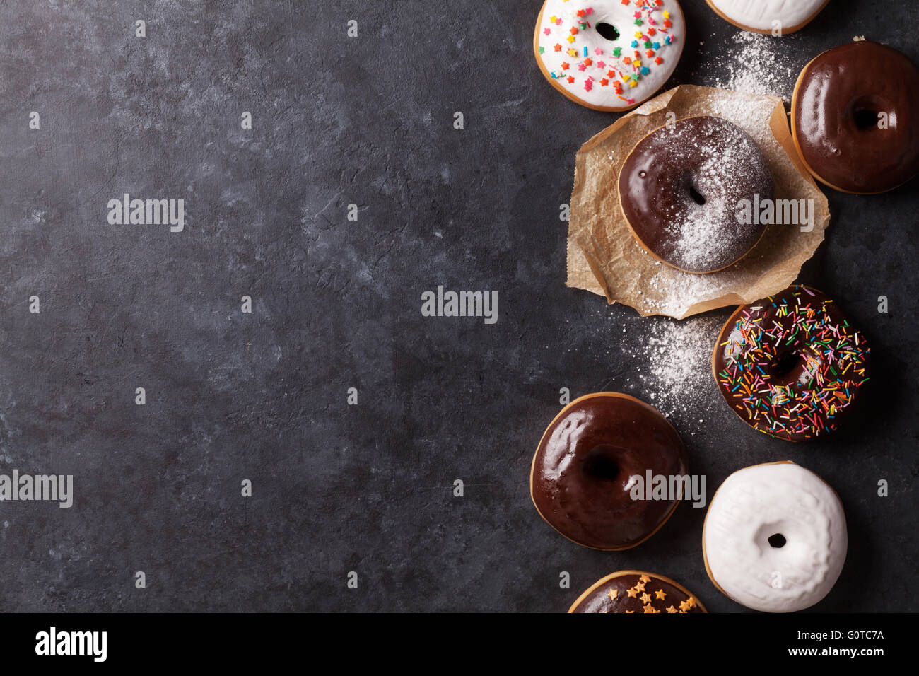 Colorful donuts on stone table. Top view with copy space Stock Photo ...