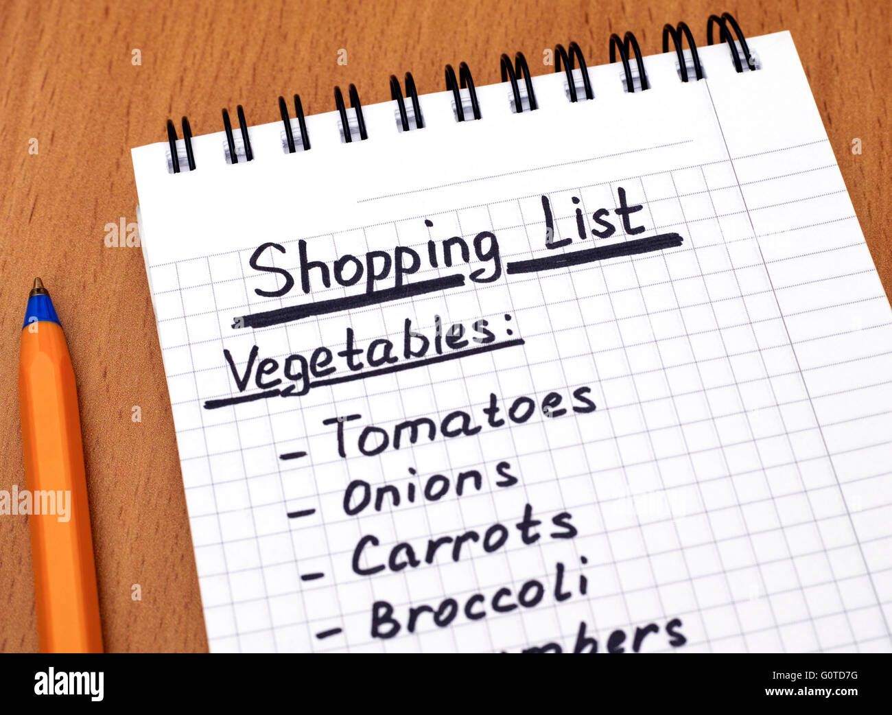 Handwritten vegetable shopping list with ballpoint pen. Closeup Stock