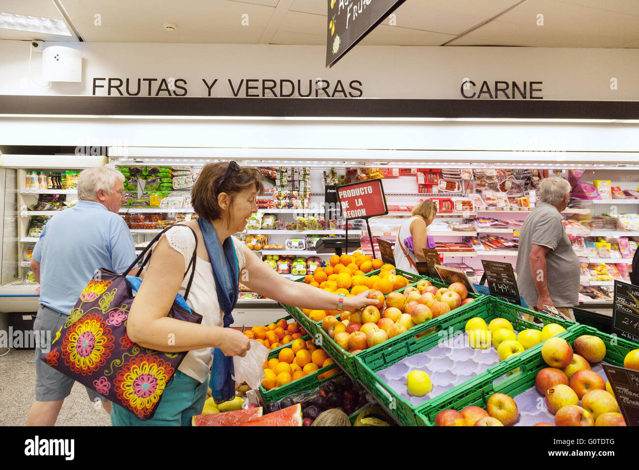 Supermarket Spain; A woman buying fruit in a spanish supermarket interior, Estepona, Andalusia Spain Europe Stock Photo