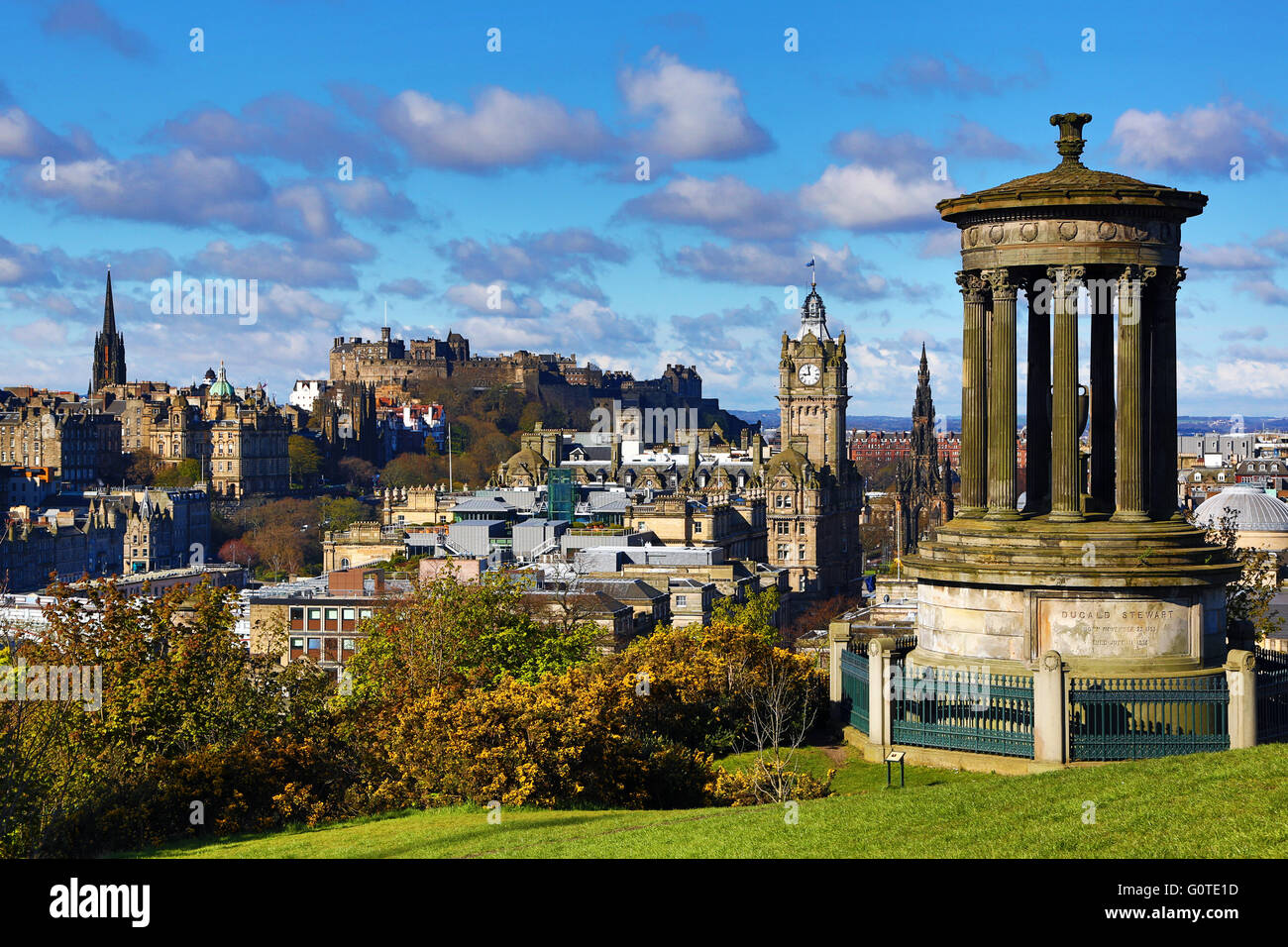 General city skyline view from Calton Hill showing the Dugald Stewart Monument and Edinburgh Castle in Edinburgh, Scotland, UK Stock Photo