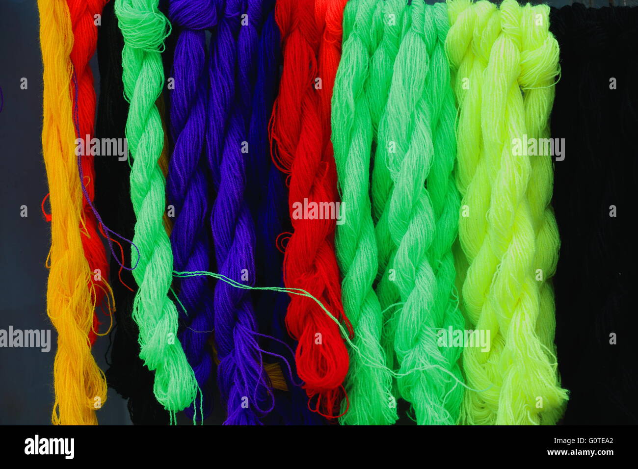 Multicolored cords of plastic yarn braided together as to form solid ropes for binding-ethiopian crafts-hanging for sale-Mek'ele Stock Photo