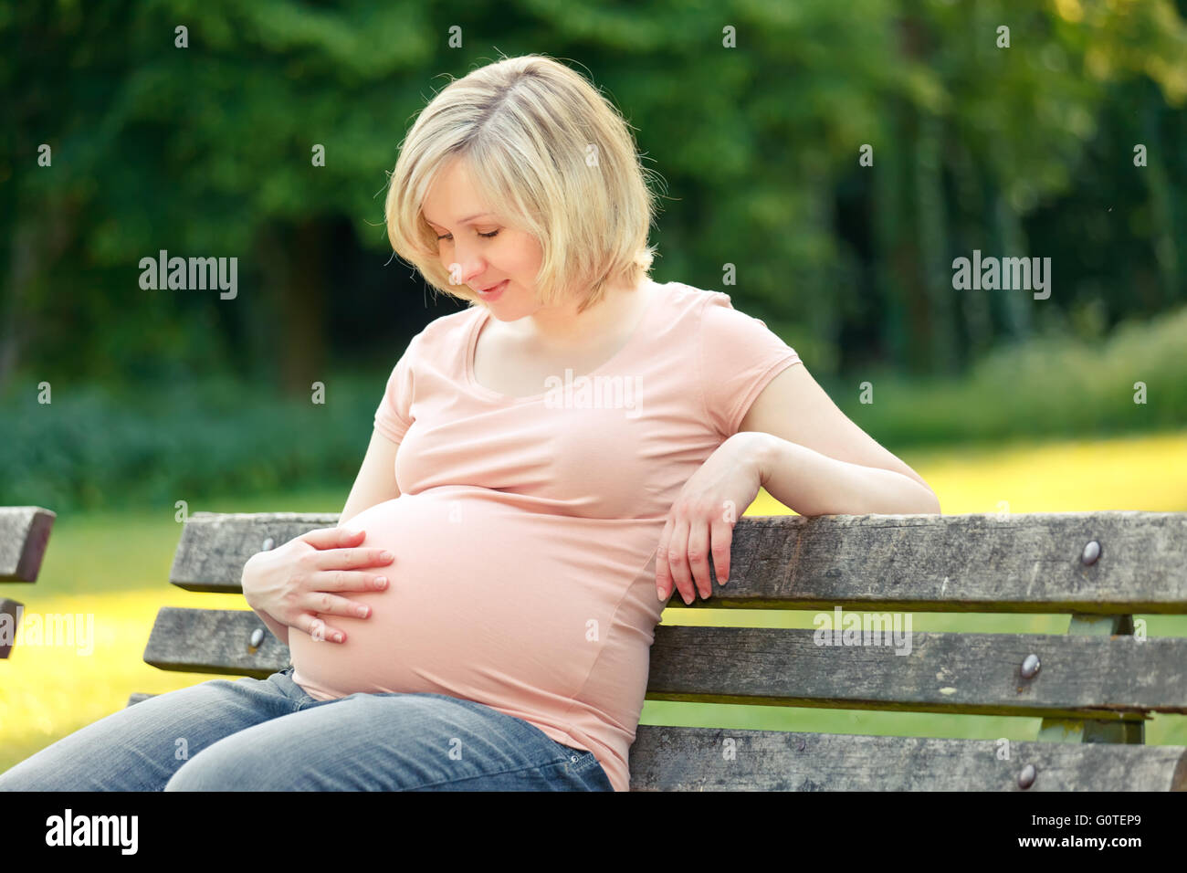 Pregnant woman in the park Stock Photo - Alamy