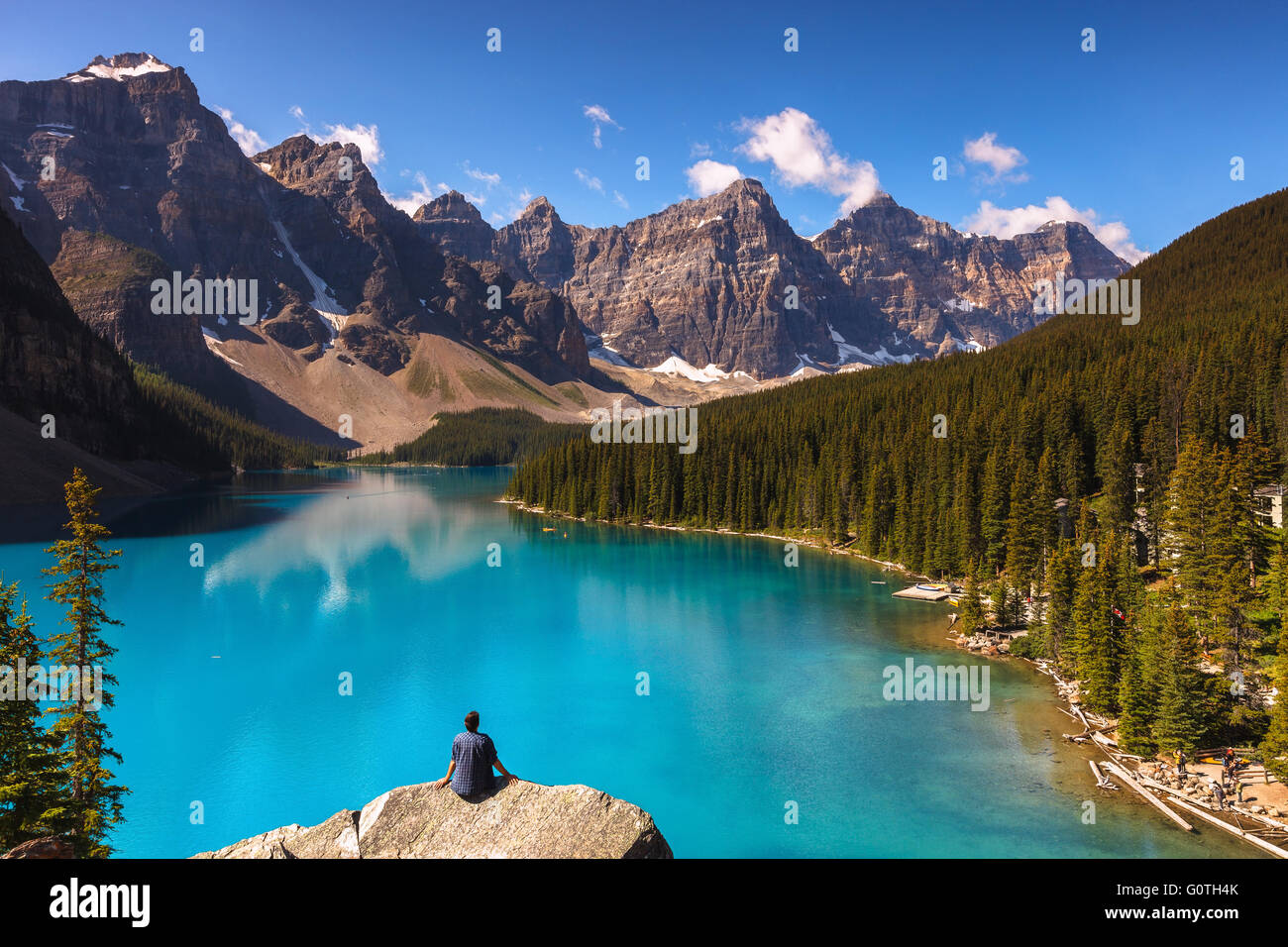 A man enjoying the view of Moraine Lake by sunrise, Banff National Park, Alberta, Canada, America (Canadian Rocky Mountains). Stock Photo