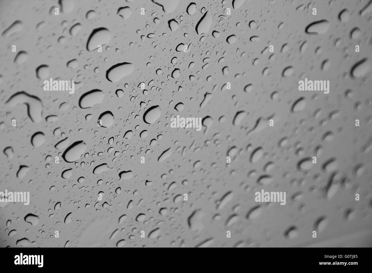 Waterdrops or raindrops   on a glass surface (Selective focus) Stock Photo
