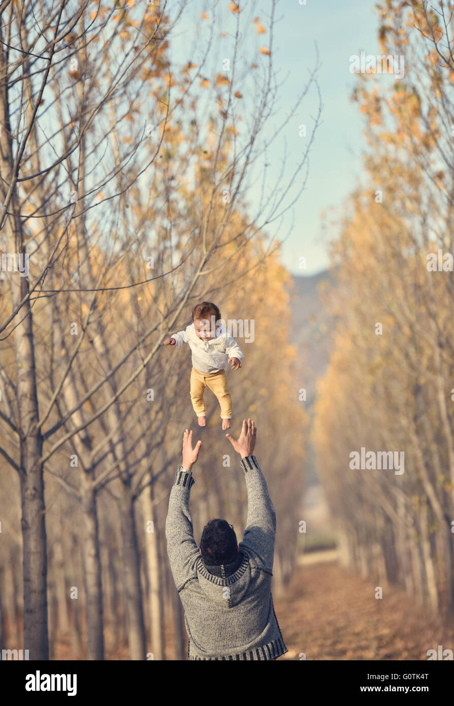 Man throwing baby girl in the air Stock Photo Alamy