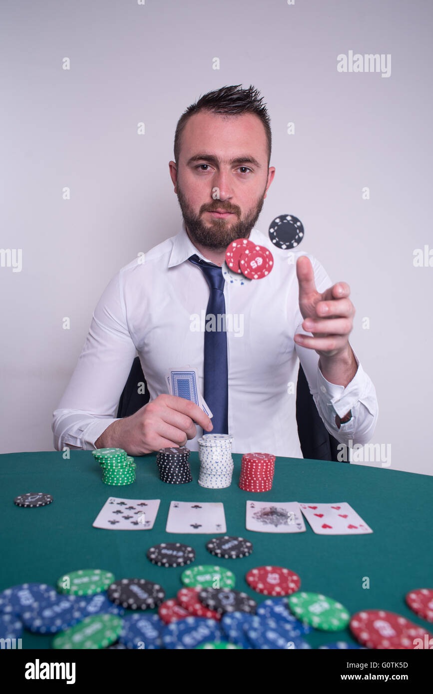 Poker player throwing gambling chips in the air Stock Photo