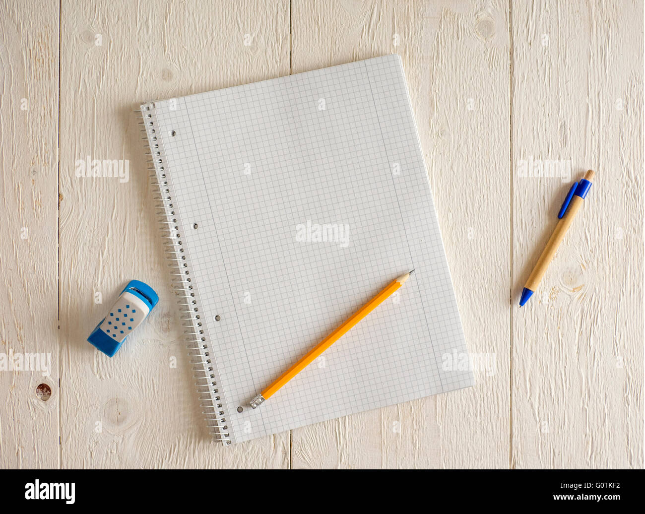 Blank notepad with pencils and eraser on table Stock Photo