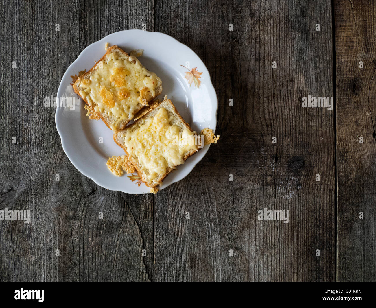 Toast with melted cheese on plate Stock Photo