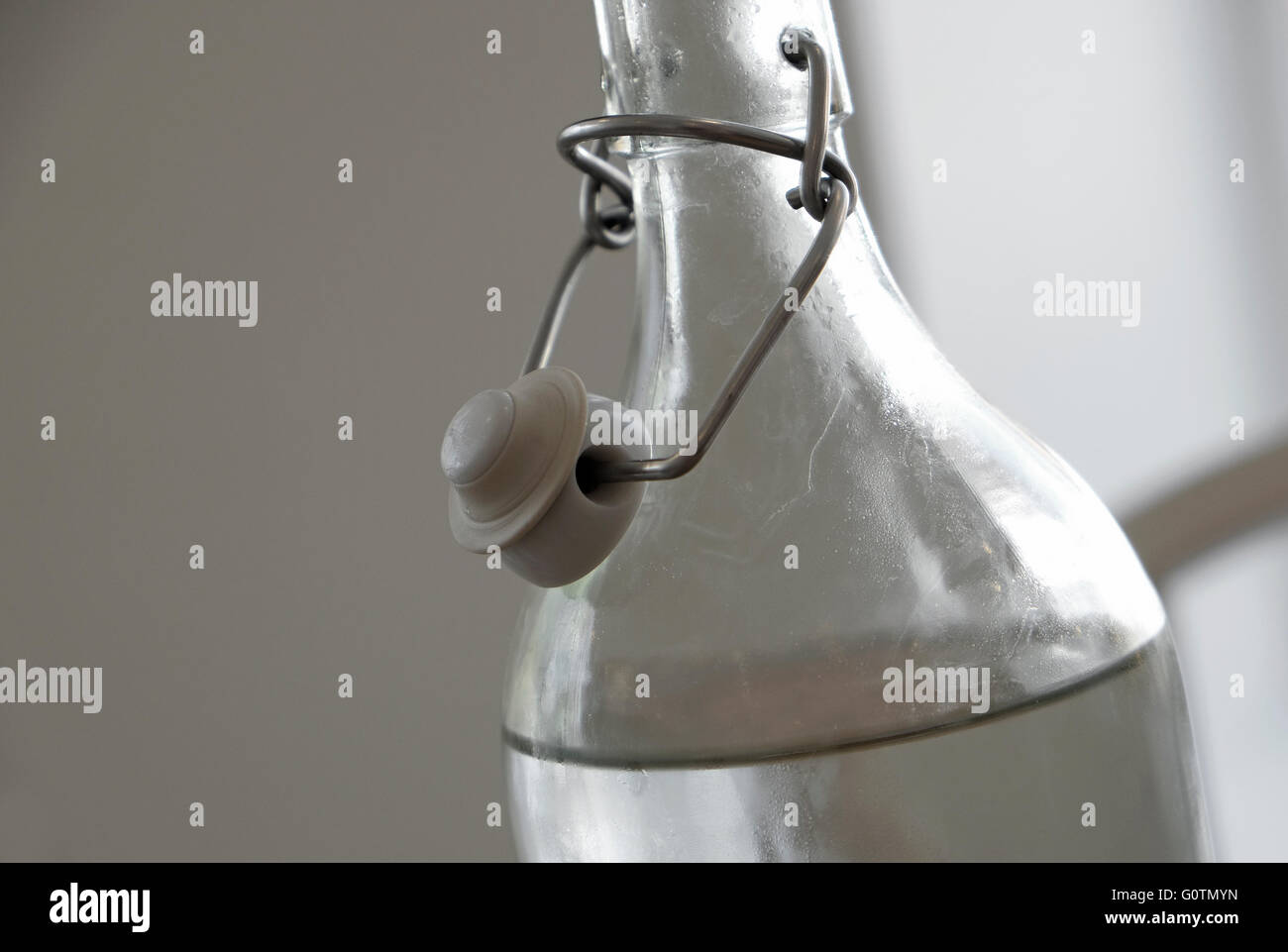 glass water bottle with metal flip top Stock Photo