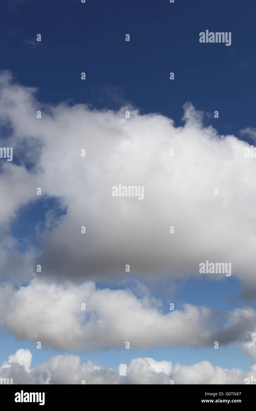 White fluffy clouds against a deep blue background during the Summer ...