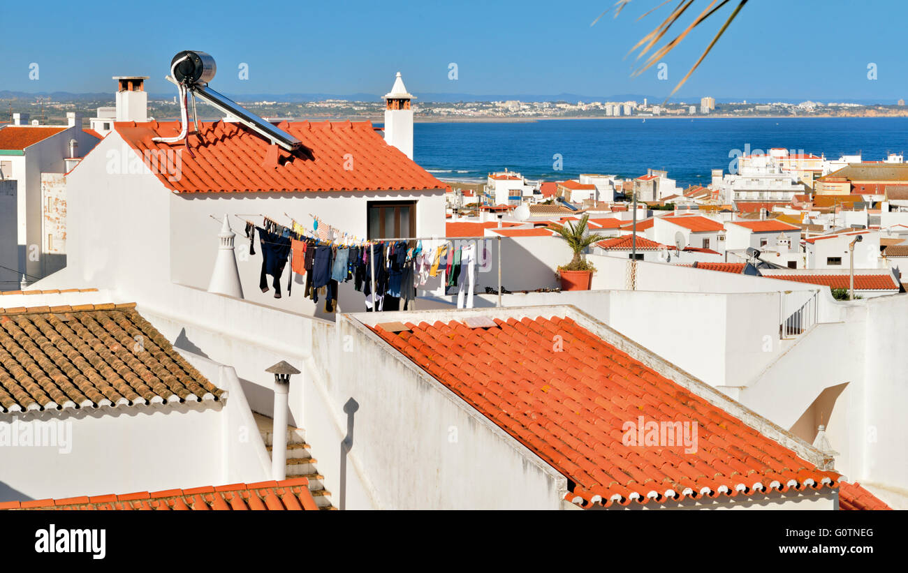 Portugal, Algarve: Overlooking the roof tops of white washed houses with Meia Praia in Lagos Stock Photo